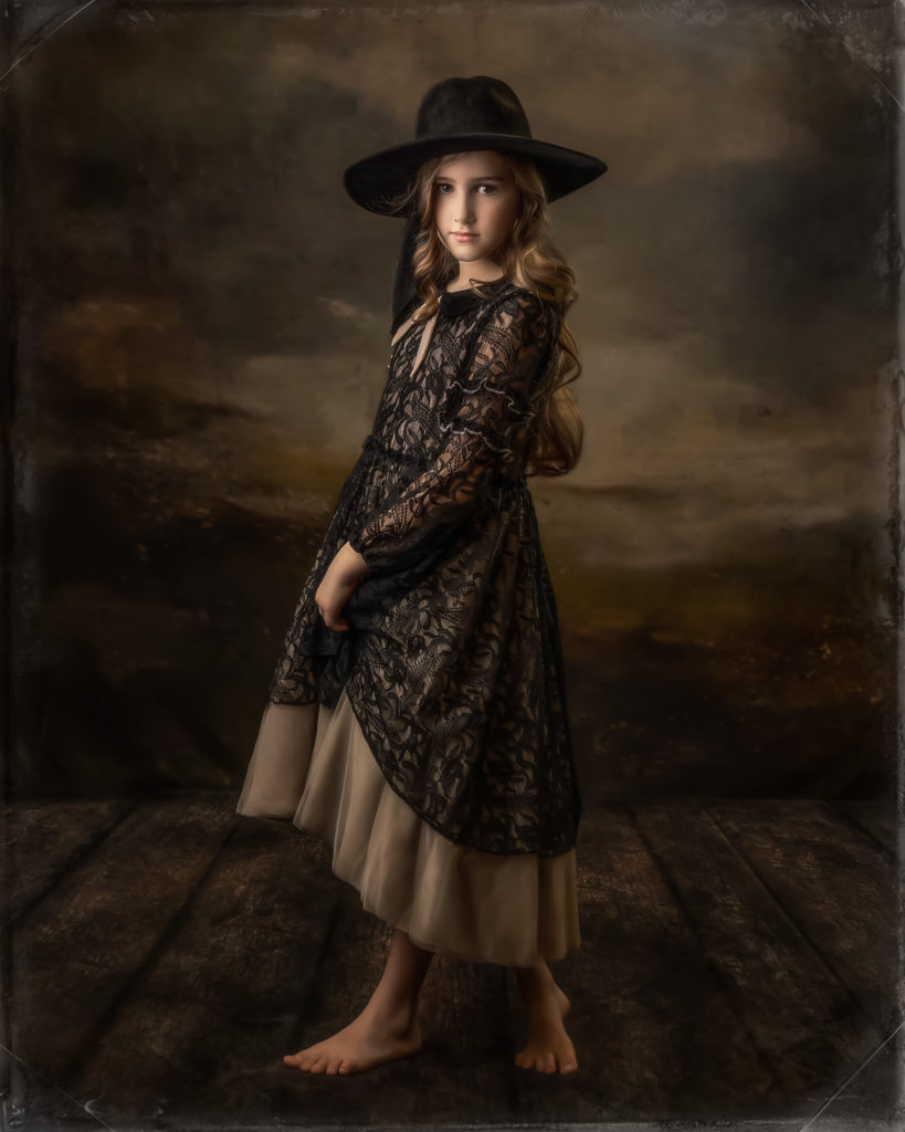 Girl in vintage dress wearing black hat