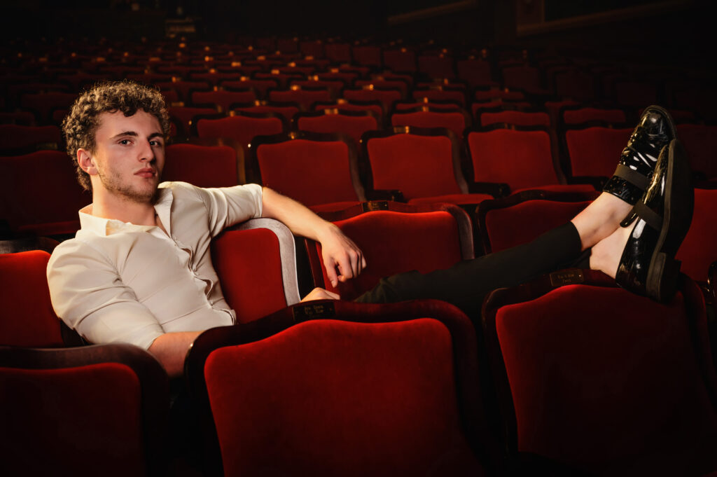 High school senior sitting in theater seats